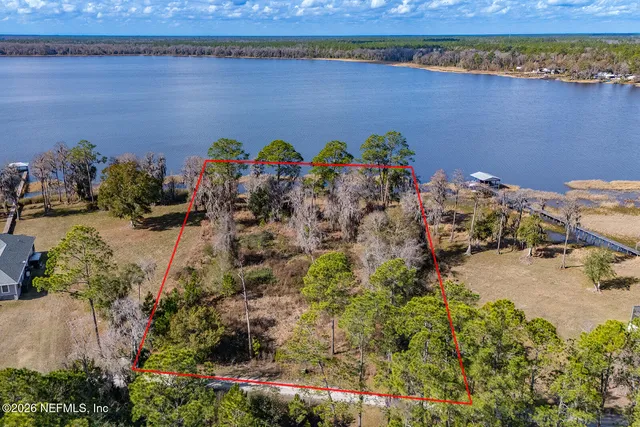 an aerial view of a house with a lake view