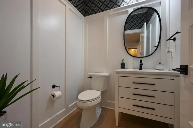a bathroom with a tub a sink and mirror