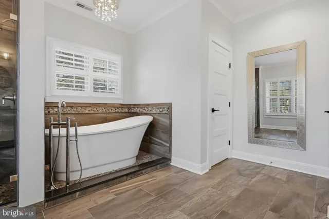 an aerial view of a house with a yard and lake view