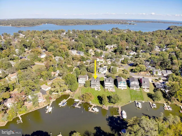 a large white kitchen with lots of counter space and stainless steel appliances