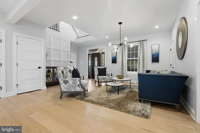 a kitchen with stainless steel appliances kitchen island granite countertop a stove top oven a sink dishwasher a dining table and chairs with wooden floor