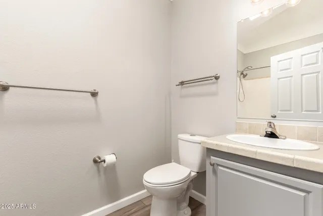 a bathroom with a sink toilet and a mirror