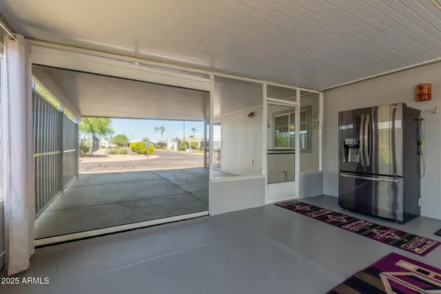 a view of a refrigerator in kitchen and window