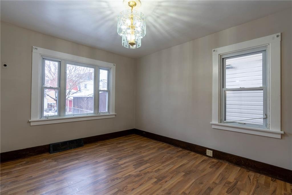 48 Sampson Avenue Pittsburgh, PA 15205 - Photo 8 of 18 a view of an empty room with wooden floor and a window