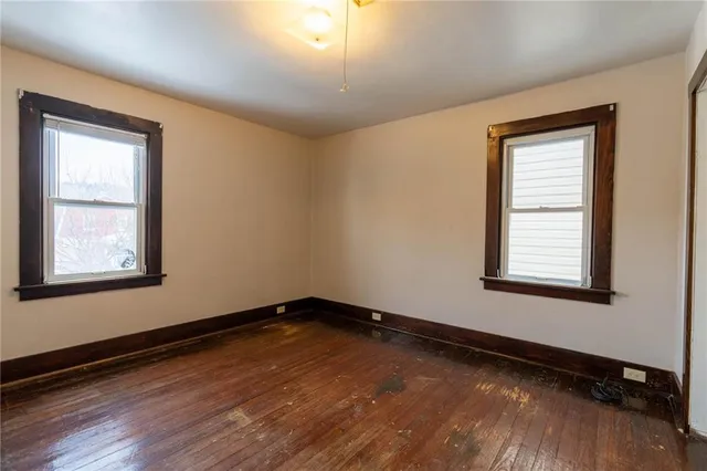 a view of a room with wooden floor and window