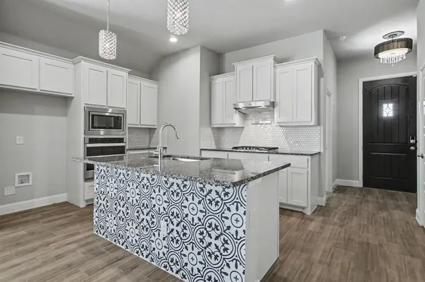 a living room with stainless steel appliances kitchen island granite countertop wooden floor and view living room