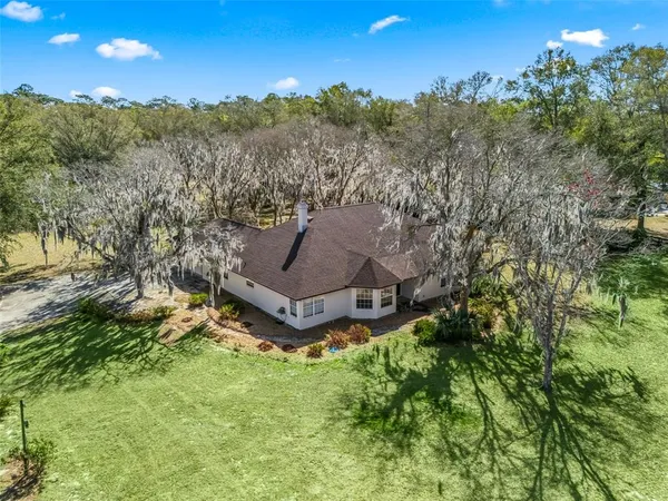 a aerial view of a house with mountain view