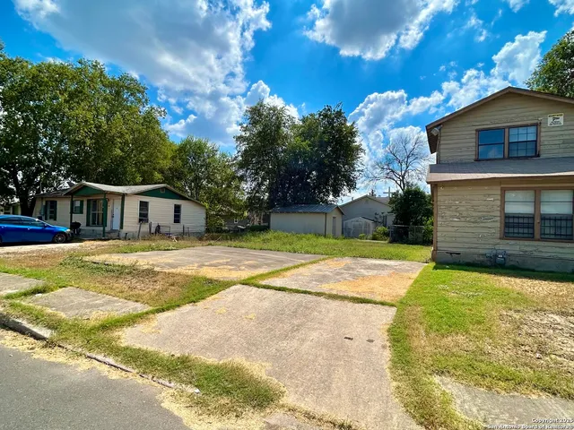 a house view with swimming pool in front of it