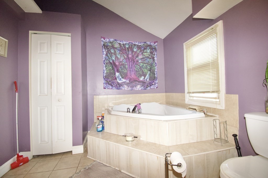 24 Rupert Street Springfield, MA 01108 - Photo 21 of 23 a bath tub sitting next to a white sink and a toilet