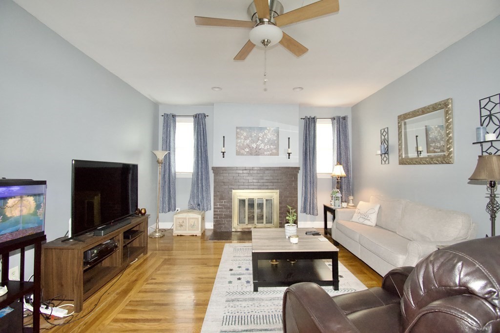 24 Rupert Street Springfield, MA 01108 - Photo 3 of 23 a living room with furniture and a flat screen tv