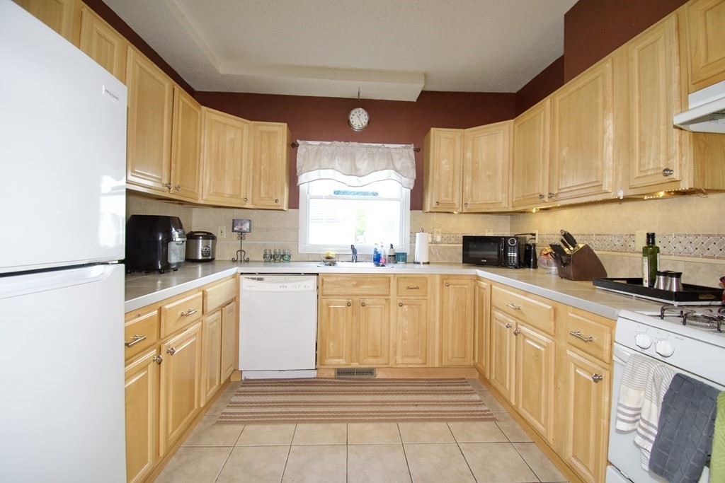 24 Rupert Street Springfield, MA 01108 - Photo 5 of 23 a kitchen with stainless steel appliances granite countertop a refrigerator sink stove microwave and cabinets