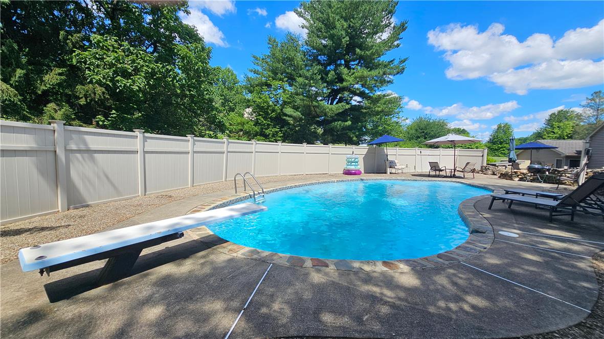 585 Buttermilk Road Hellertown, PA 18055 - Photo 42 of 82 An inviting backyard oasis offers a pristine inground pool, perfect for summer relaxation.