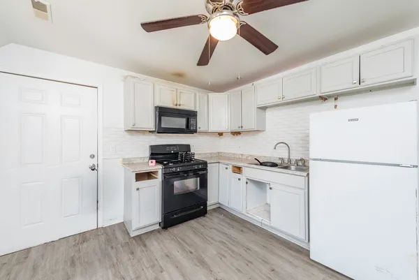 a kitchen with a stove and a microwave