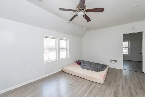 a view of a bedroom with a bed and a window
