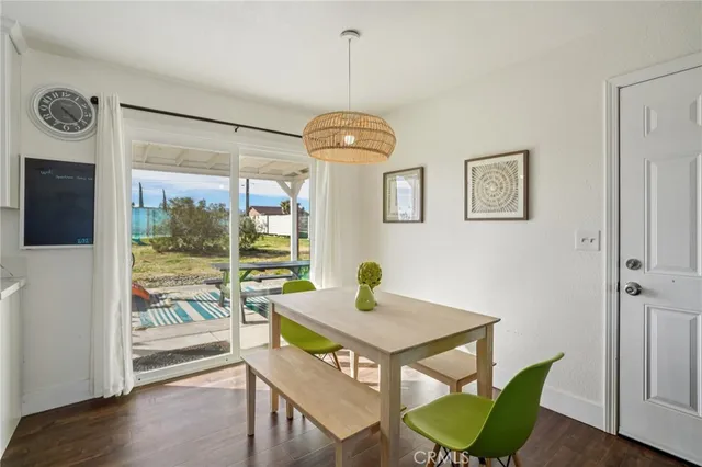a kitchen with a table chairs appliances and cabinets