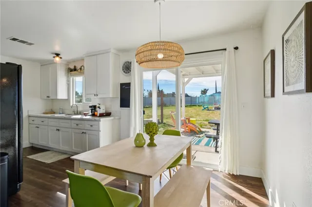 a kitchen with stainless steel appliances granite countertop a refrigerator a stove and a sink with dishwasher