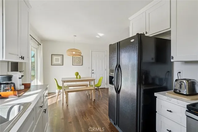 a kitchen with stainless steel appliances wooden cabinets and a refrigerator