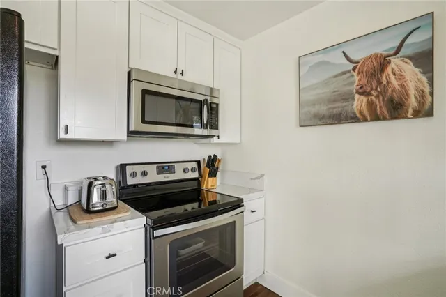 a kitchen with a sink cabinets and wooden floor