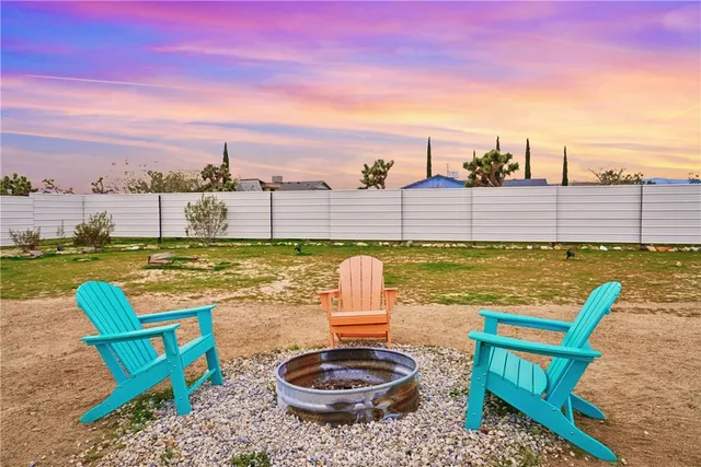 a view of living room kitchen with patio and garden