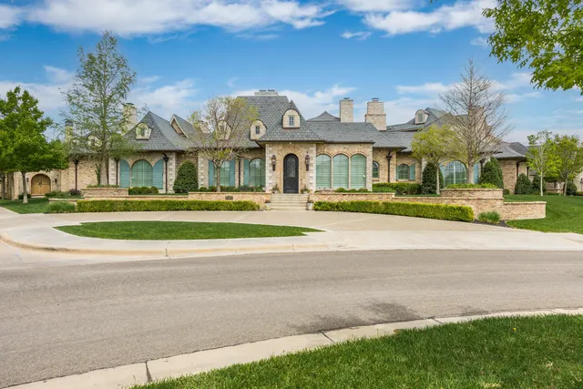 a front view of residential houses with yard and green space