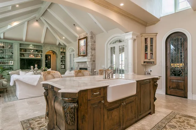 a living room with furniture a lamp and a table