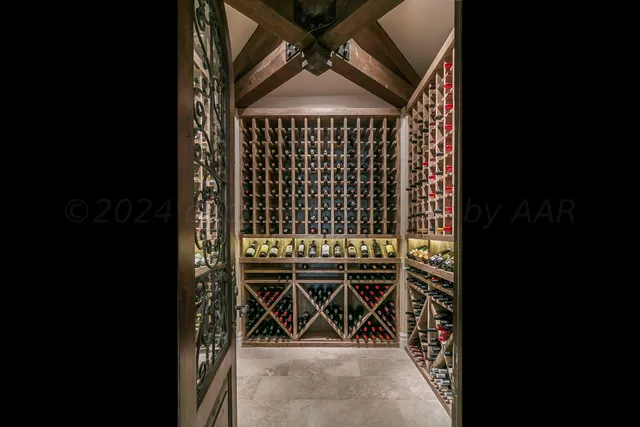 a bathroom with a double vanity sink a mirror and a bathtub