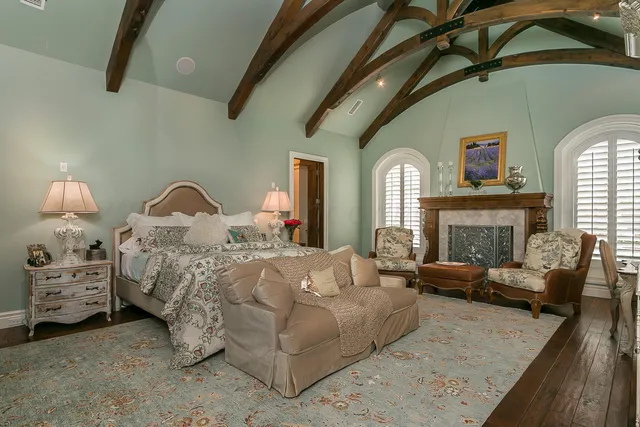 a bathroom with a granite countertop sink a mirror and shower