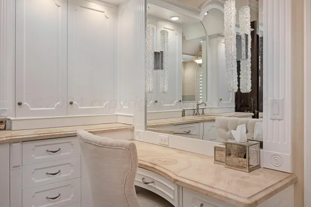 a bathroom with a granite countertop sink a toilet a shower and a mirror