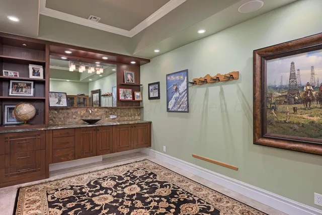 a view of a patio with a table chairs and a floor to ceiling window