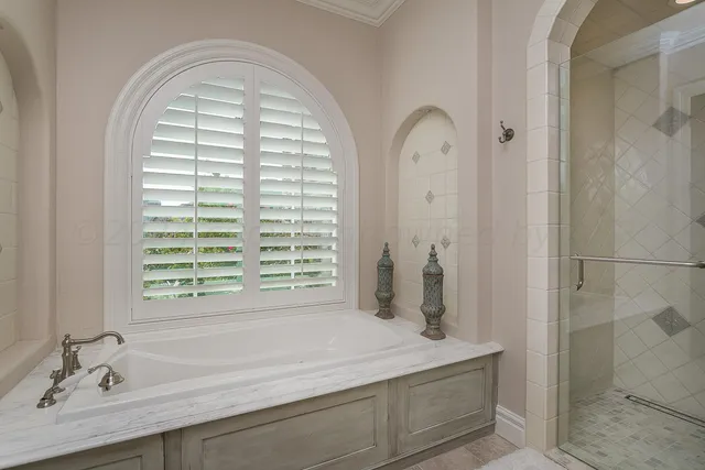 a front view of a house with a yard and fountain