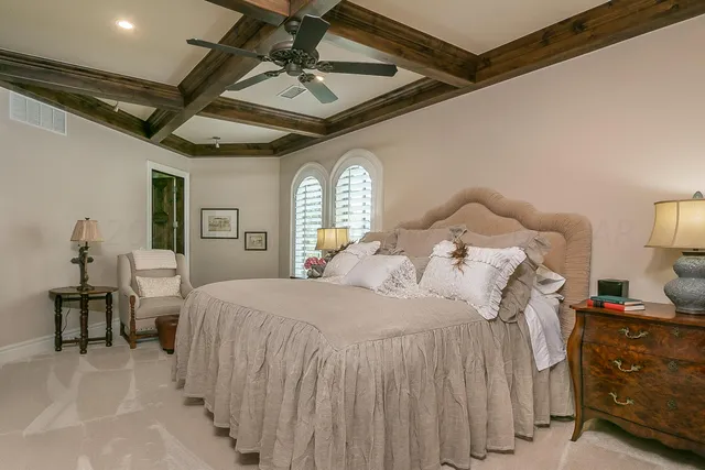 a front view of a house with a garden and yard