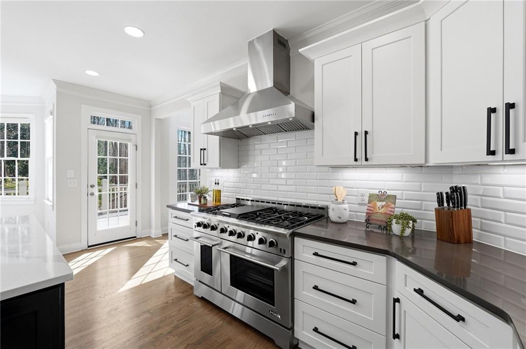 800 Barberry Drive Milton, GA 30004 - Photo 22 of 63 a kitchen with stainless steel appliances granite countertop a stove and a white cabinets