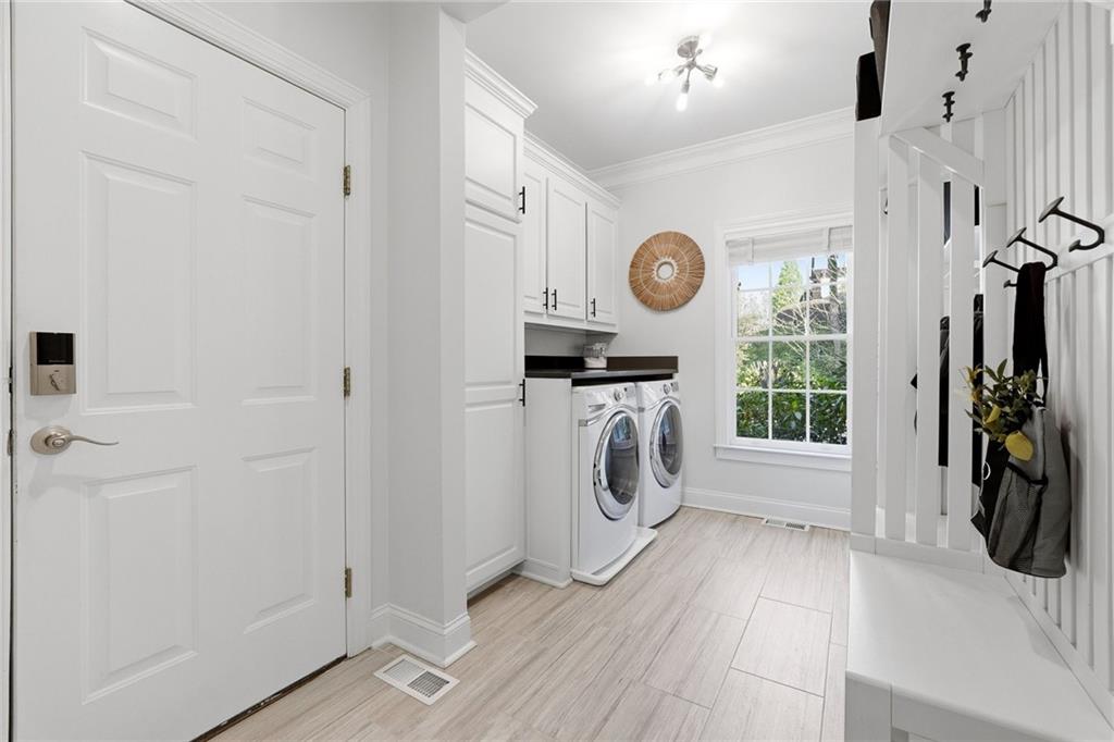 800 Barberry Drive Milton, GA 30004 - Photo 24 of 63 a view of a hallway with a washer and dryer