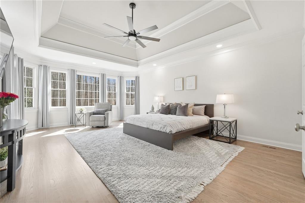 800 Barberry Drive Milton, GA 30004 - Photo 26 of 63 a bedroom with a large bed and a chandelier