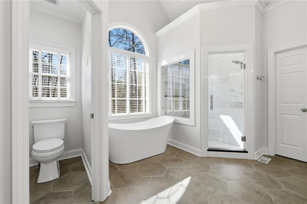 800 Barberry Drive Milton, GA 30004 - Photo 28 of 63 a bathroom with a toilet tub and a window