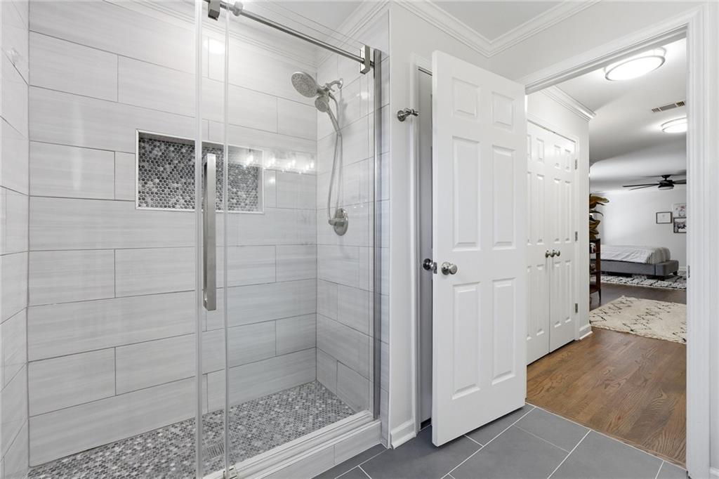 800 Barberry Drive Milton, GA 30004 - Photo 36 of 63 a bathroom with a glass shower door