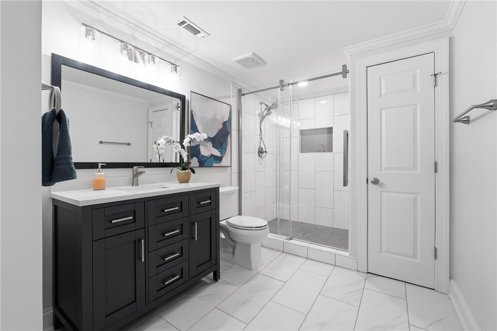 800 Barberry Drive Milton, GA 30004 - Photo 41 of 63 a bathroom with a double vanity sink toilet and shower
