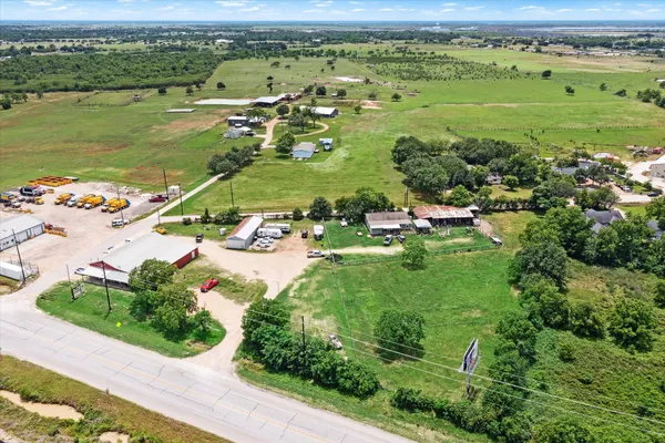 an aerial view of ocean with residential house and outdoor space