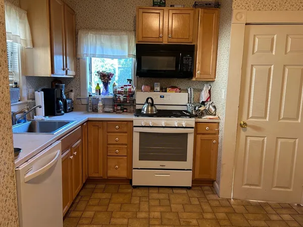 a kitchen with stainless steel appliances a stove a sink and a microwave