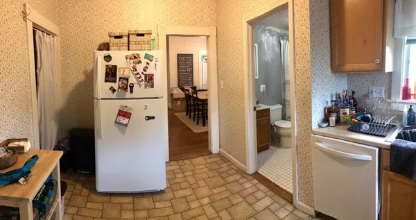 a kitchen with refrigerator and cabinet