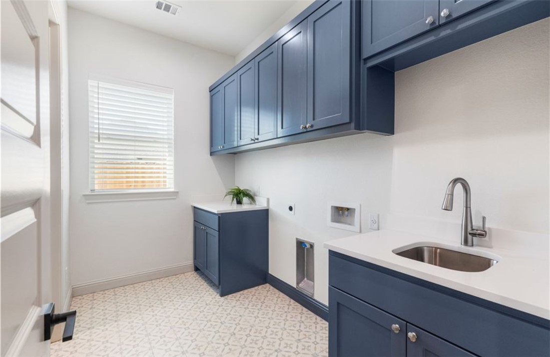5102 Greenstone Way Bryan, TX 77802 - Photo 18 of 29 a kitchen with stainless steel appliances granite countertop a sink dishwasher a stove and a refrigerator with wooden cabinets