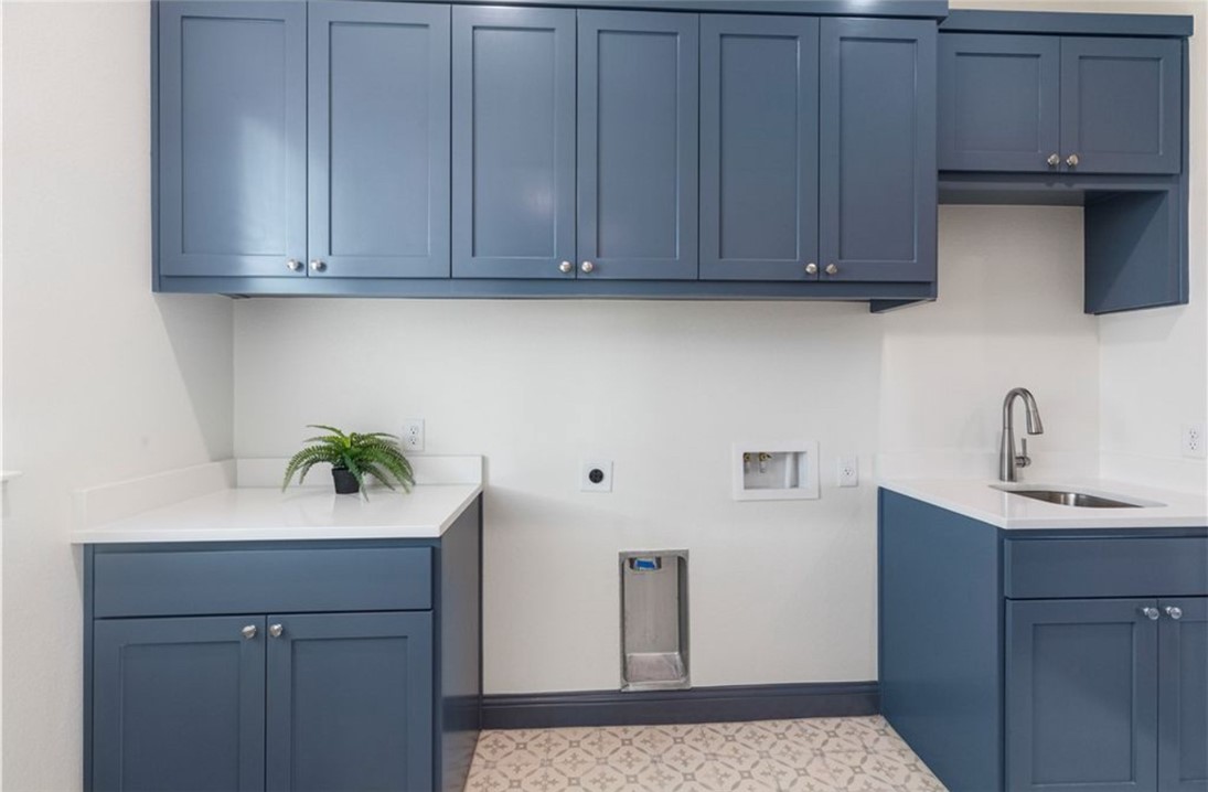 5102 Greenstone Way Bryan, TX 77802 - Photo 19 of 29 a view of cabinets a sink and a microwave in a shelf
