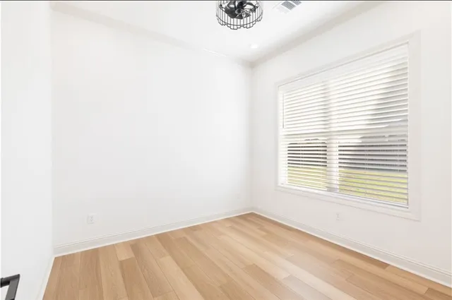 a view of walk in closet with empty racks