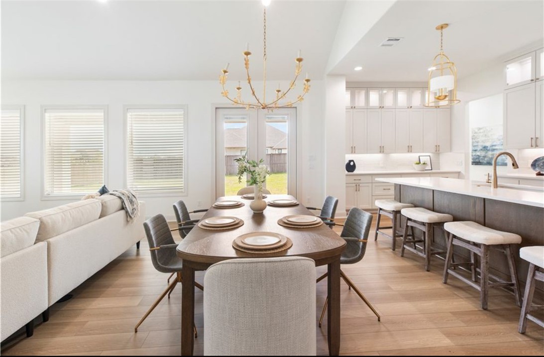 5102 Greenstone Way Bryan, TX 77802 - Photo 3 of 29 a view of a dining room with furniture and a large window