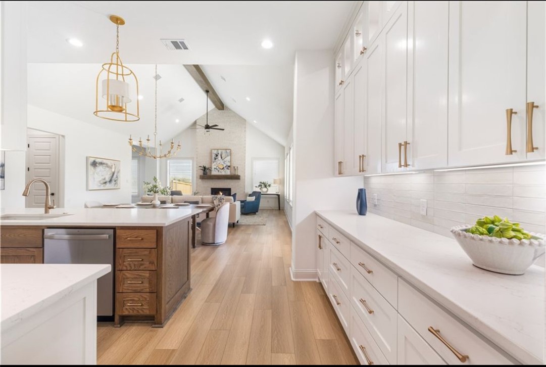 5102 Greenstone Way Bryan, TX 77802 - Photo 5 of 29 a large white kitchen with stainless steel appliances lots of counter space and wooden floor