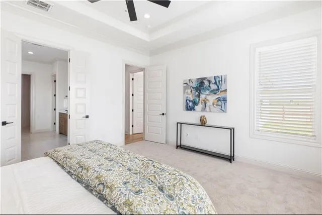 a large white kitchen with stainless steel appliances lots of counter space and wooden floor