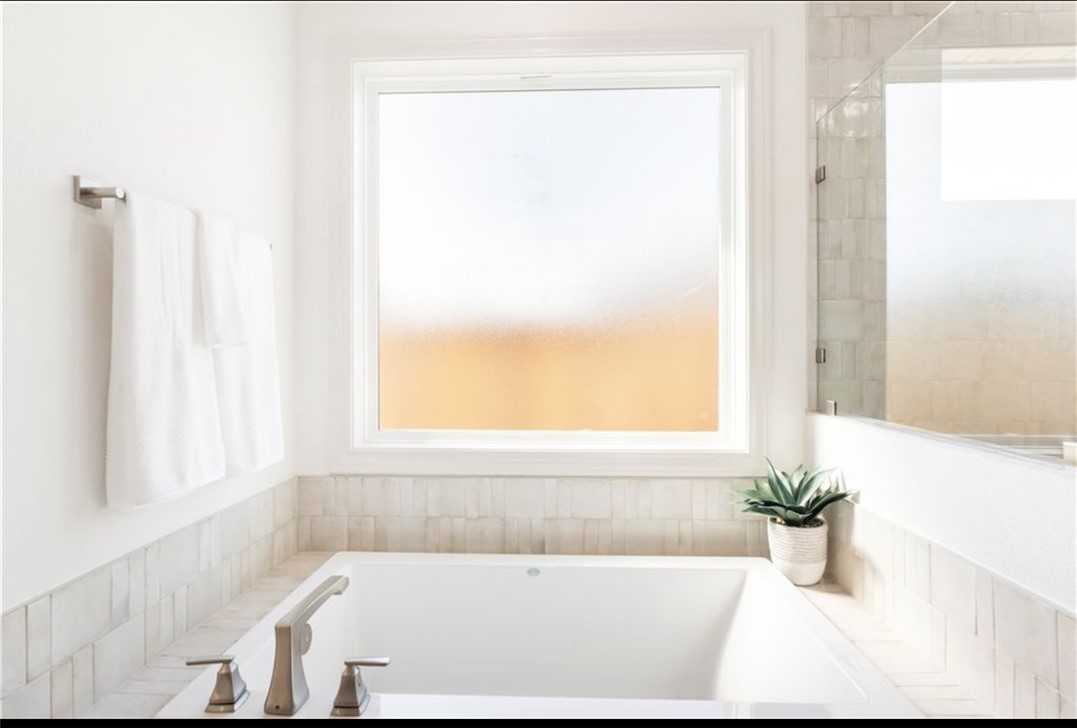 5102 Greenstone Way Bryan, TX 77802 - Photo 8 of 29 a white bath tub sitting next to a window