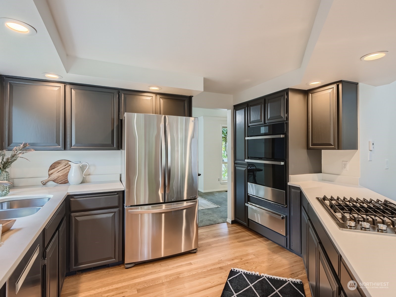 24207 15th Place Southeast Bothell, WA 98021 - Photo 6 of 27 a kitchen with granite countertop a refrigerator and a stove top oven