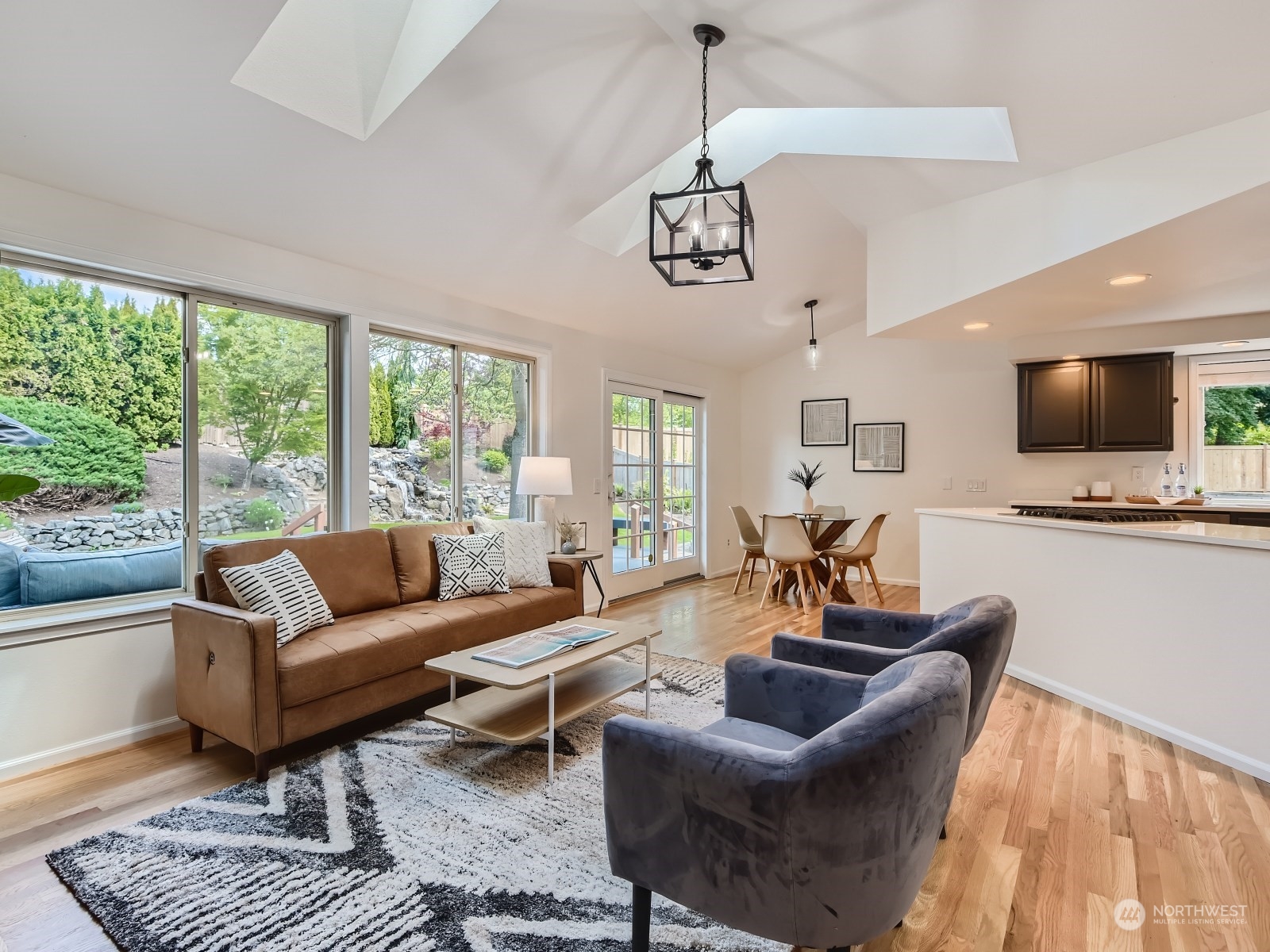 24207 15th Place Southeast Bothell, WA 98021 - Photo 10 of 27 a living room with furniture a flat screen tv and a large window