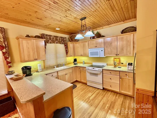 a kitchen with stainless steel appliances kitchen island granite countertop a sink and cabinets